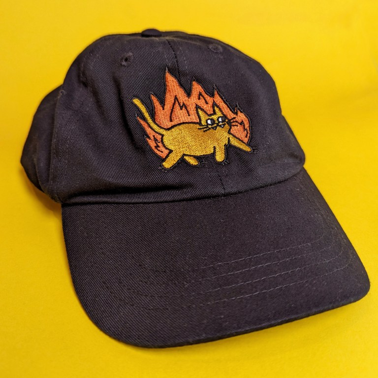 black dad cap with fire cat – yellow background- 3