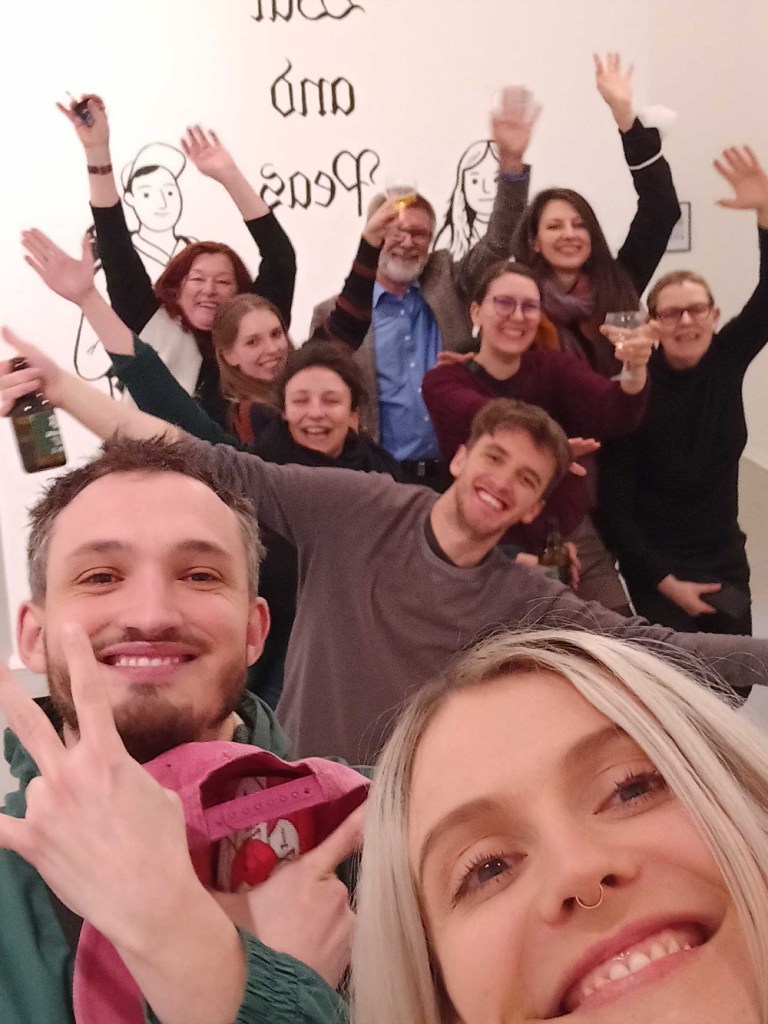 Jonathan Kunz and Elizabeth Pich posing with friends in their first solo exhibition