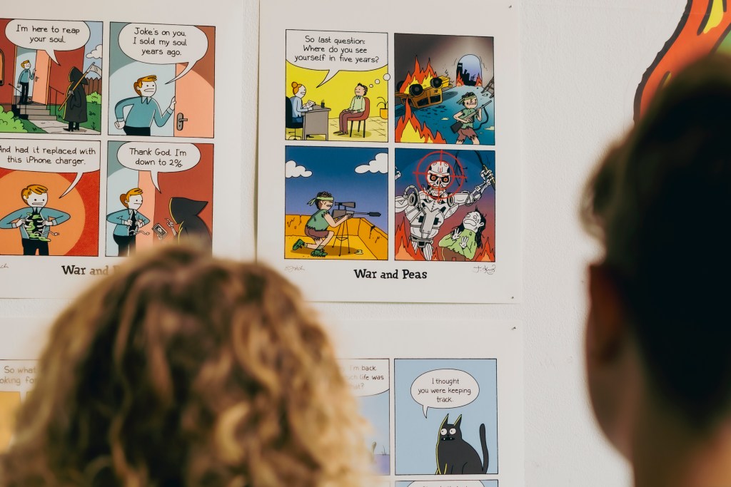 People reading War and Peas comics at exhibition.
Photo: Tina Stariha / Kino Šiška