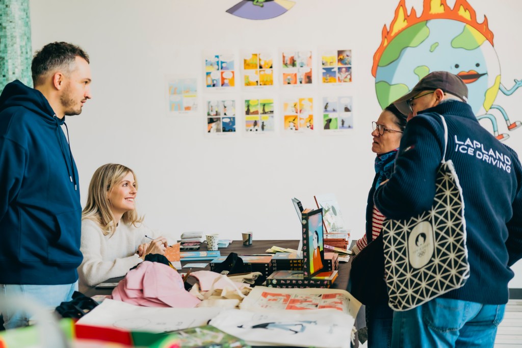 Elizabeth Pich talking to readers at the market of Tinta Stripa. Jonathan Kunz stands next to her. Photo: Tina Stariha / Kino Šiška