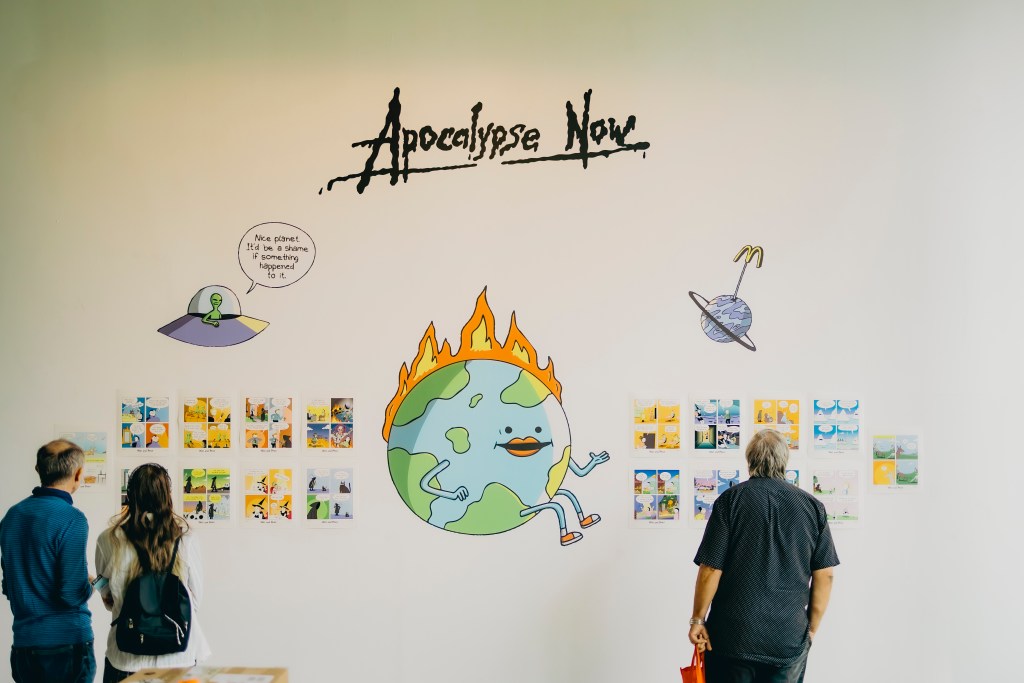 People looking at comic art exhibition at festival Tinta Stripa. Funny webcomics by War and Peas. Photo: Tina Stariha / Kino Šiška